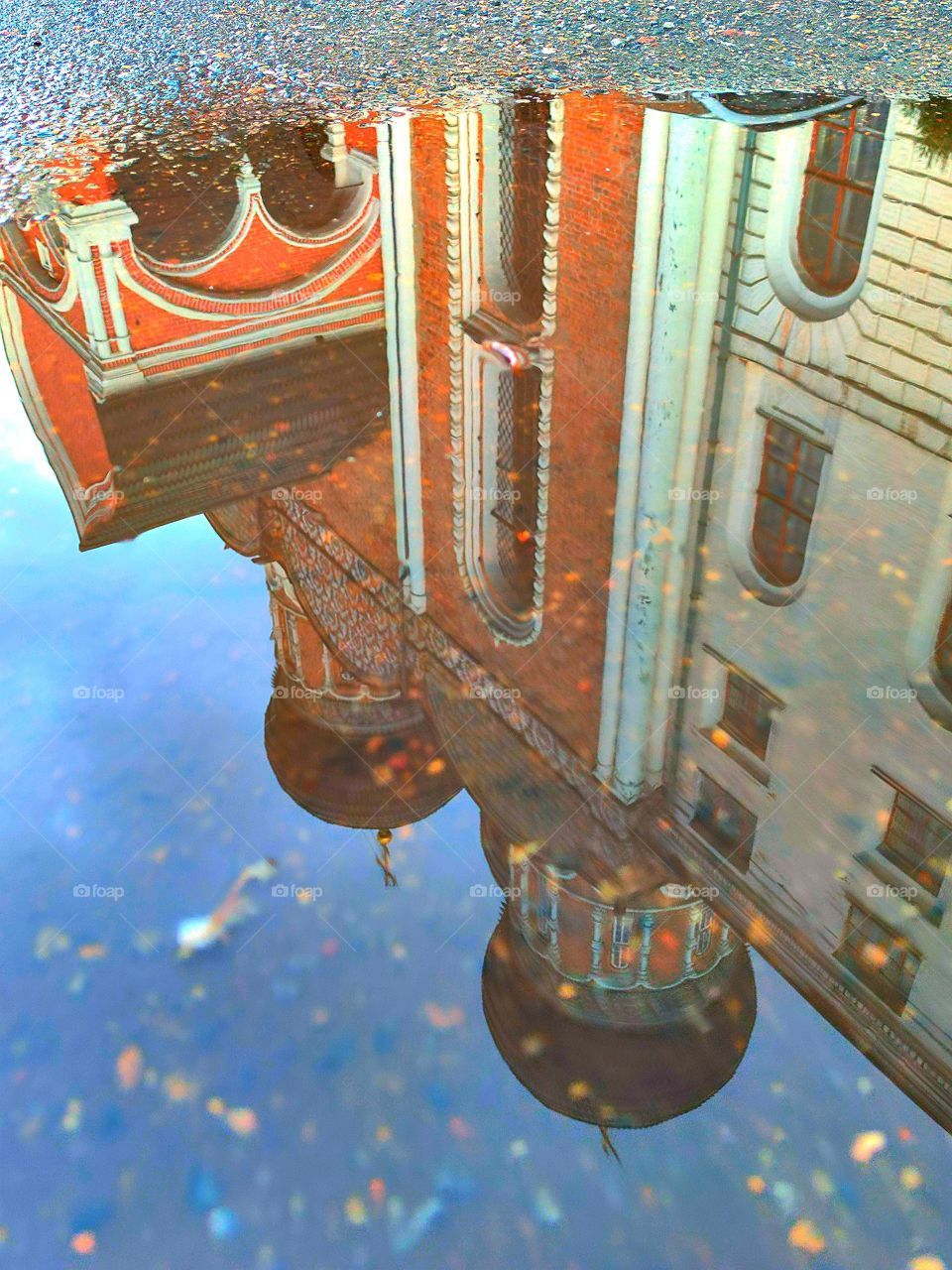 Wet asphalt, which reflects the ancient temple with domes