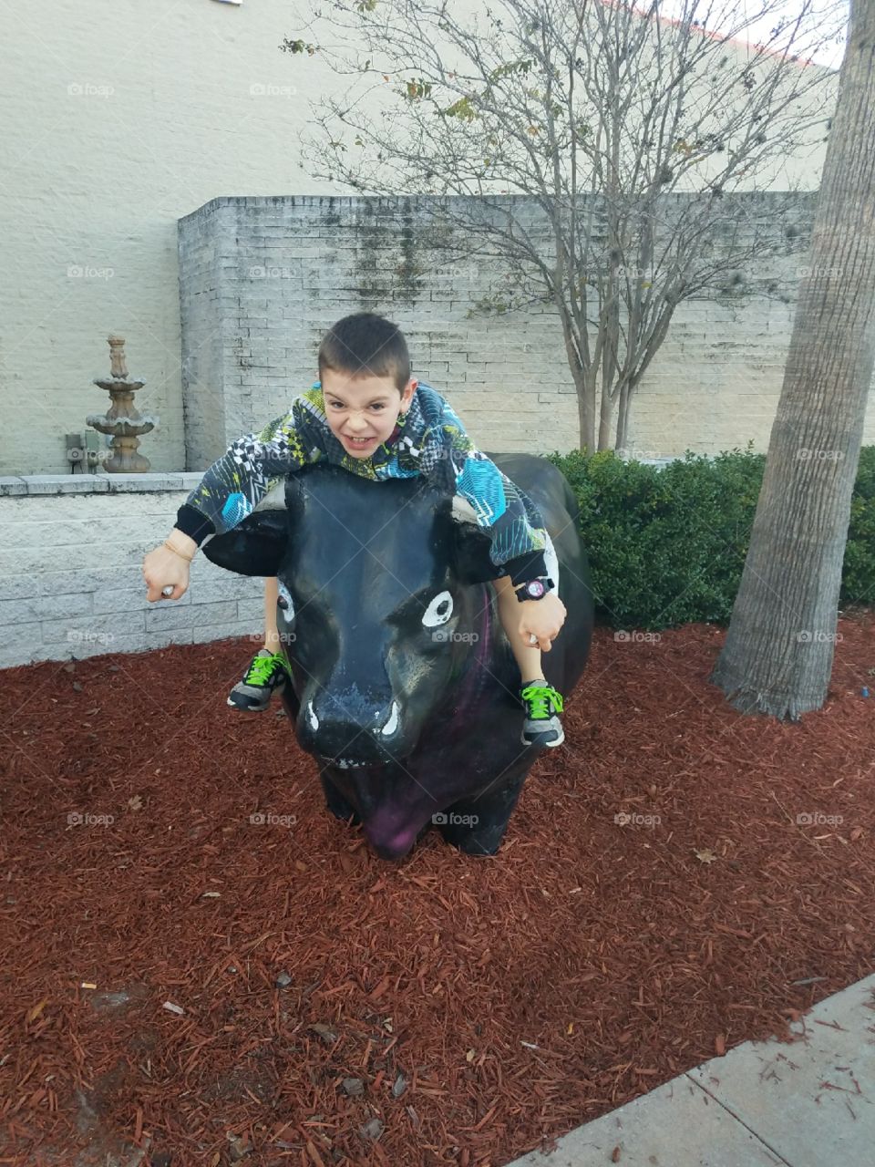 Caleb riding a bull outside the mall he’s holding on tight what a cowboy!!!!