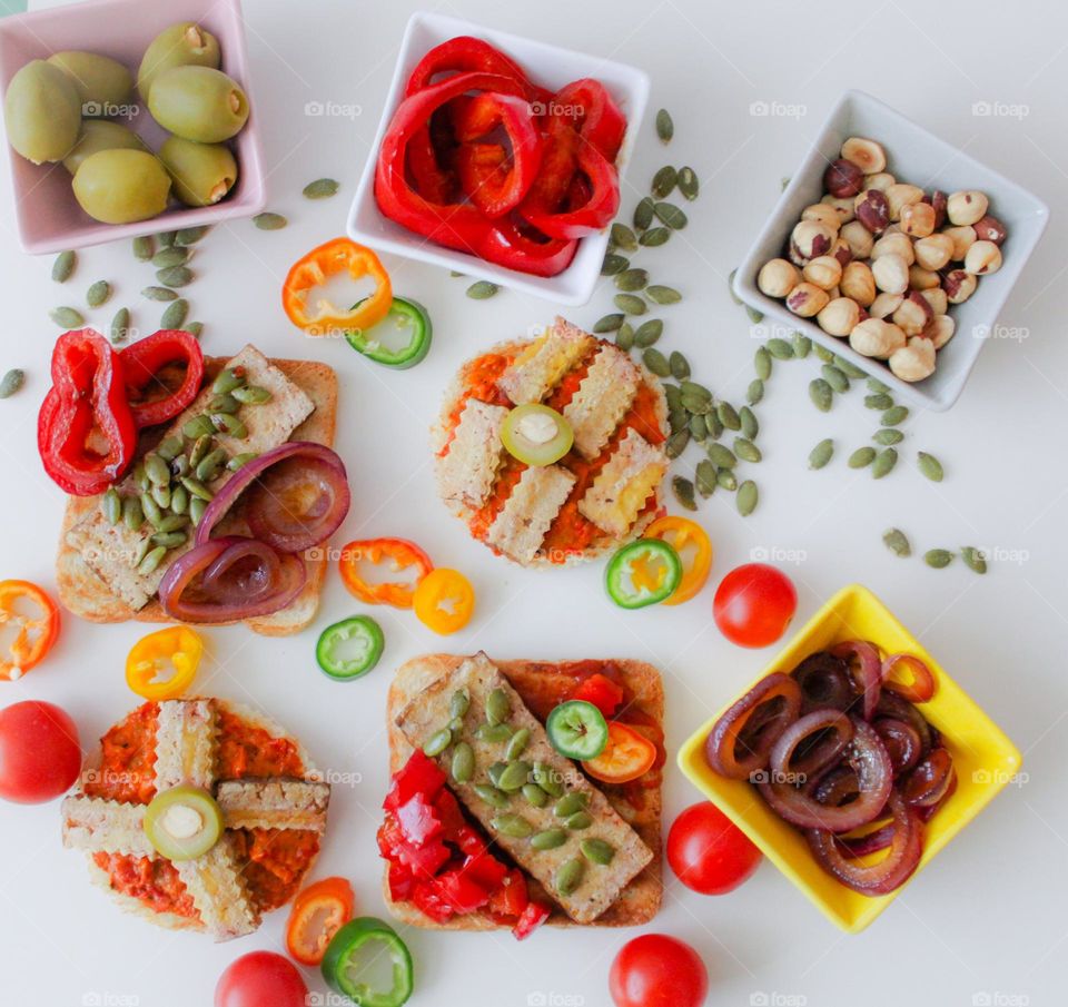 Colorful vegan and vegetarian breakfast. Paprika,  olives, caramelized onion,  toast,  hot peppers, seeds,  papeika sauce (ajvar)