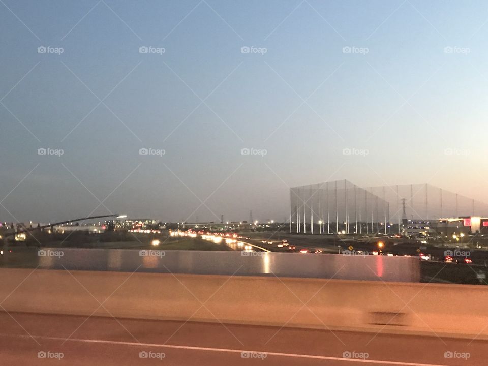 Driving over the overpass on the freeway - passing the bright lights of the cars 