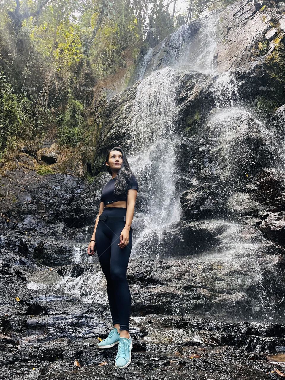 A hiking woman enjoying the waterfall 