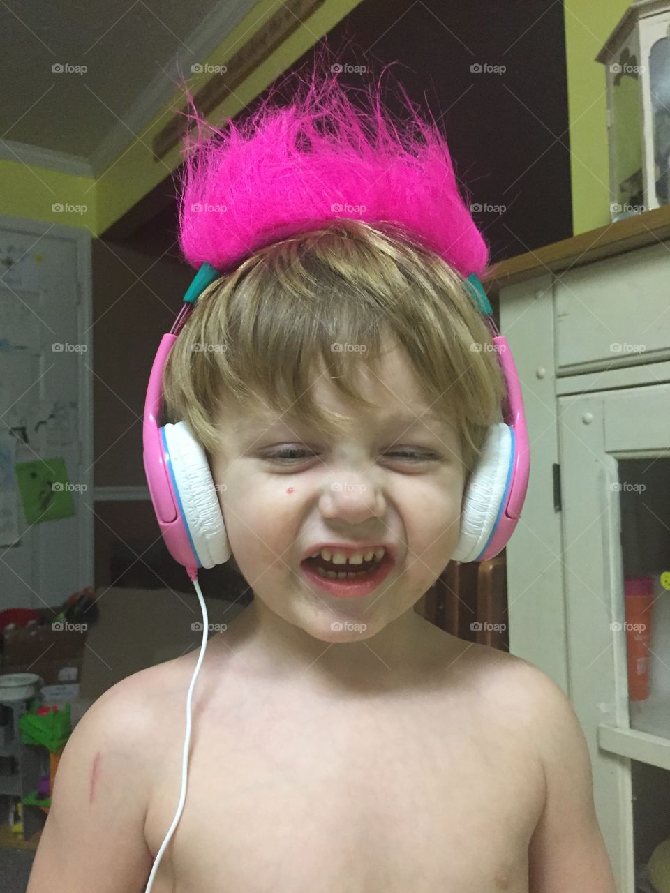Cute expressive kid listening to music