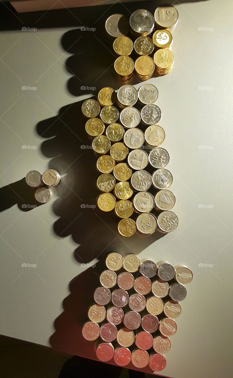 pillers of coins and shadow