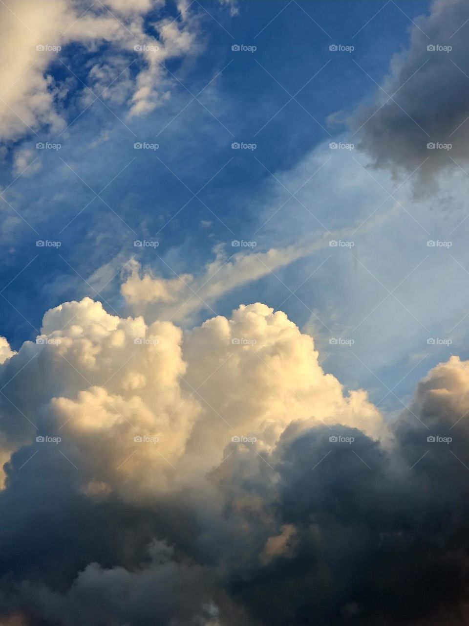 Fluffy clouds with a sky hinting at rain