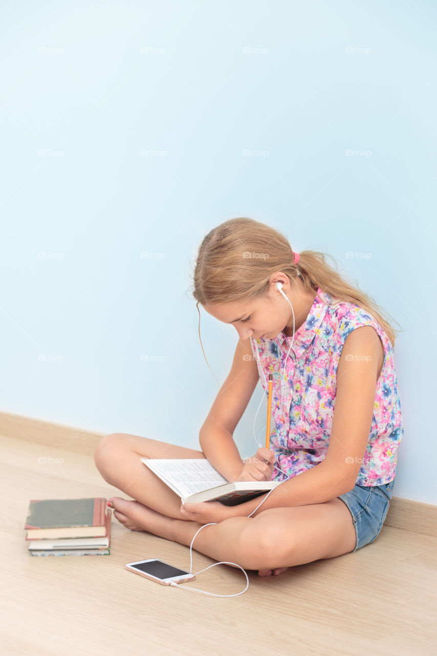 Girl studying in home with mobile phone