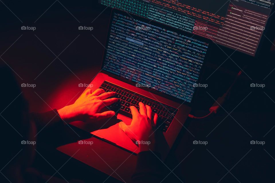 Man using computer and programming to break code. Cyber security threat. Internet and network security. Stealing private information. Person using technology to steal password and private data. Cyber attack crime