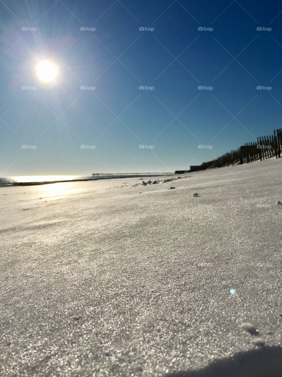 Snow and ice covered sand on the beach