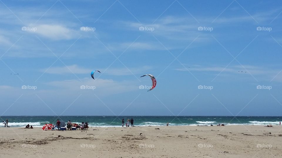 Kite surfers and other beach goers enjoying the beach