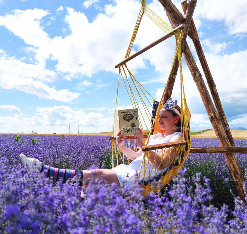 Reading in peace in the summer field of lavender