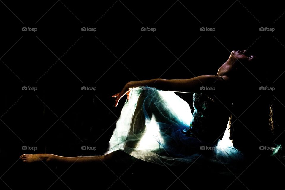 ballerina in a tutu with a bright back lighting