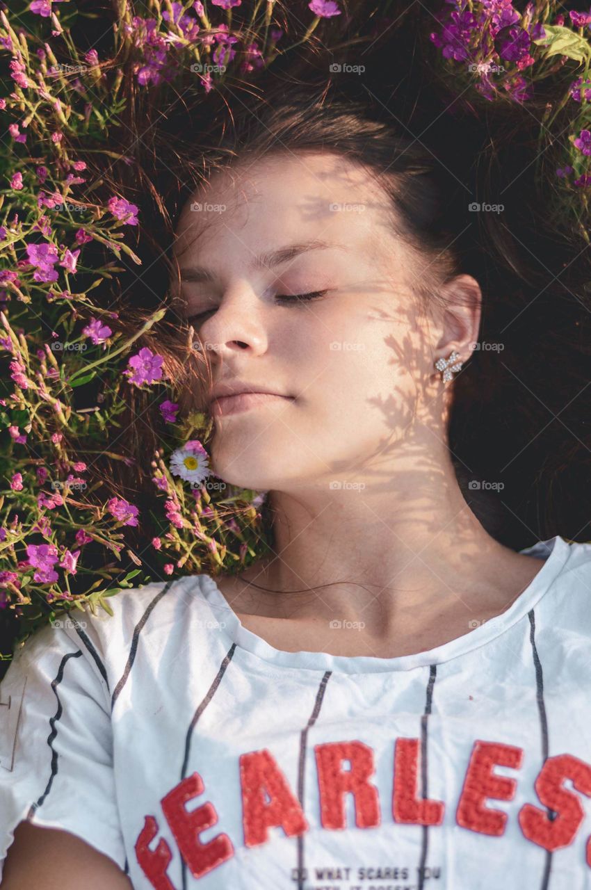 Girl laying in the flower field.