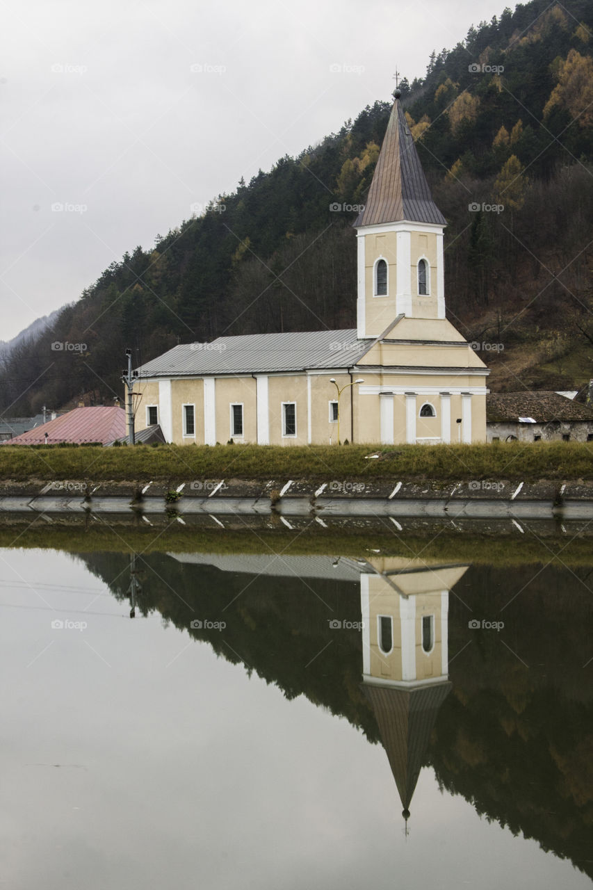 Church reflecting on river