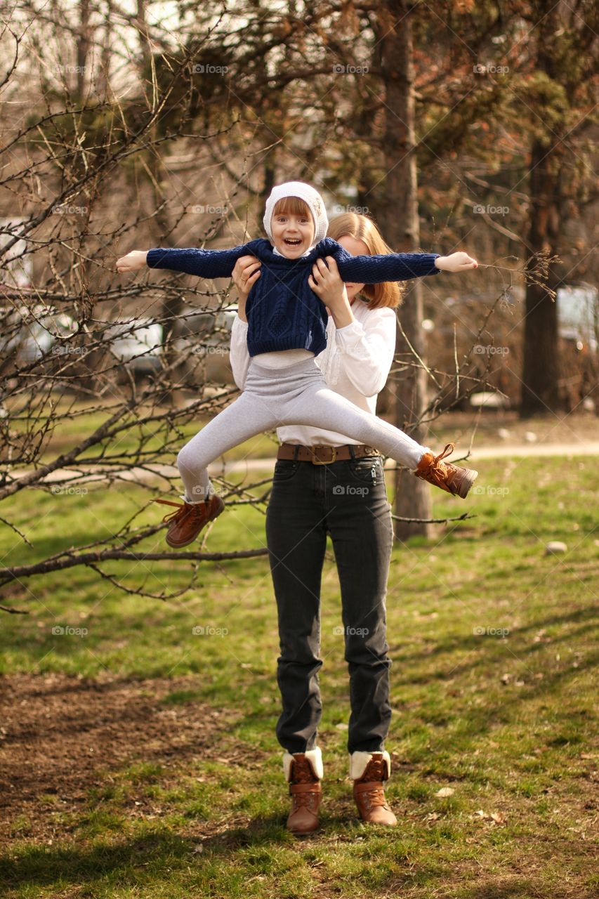 Mom plays with her daughter in the park
