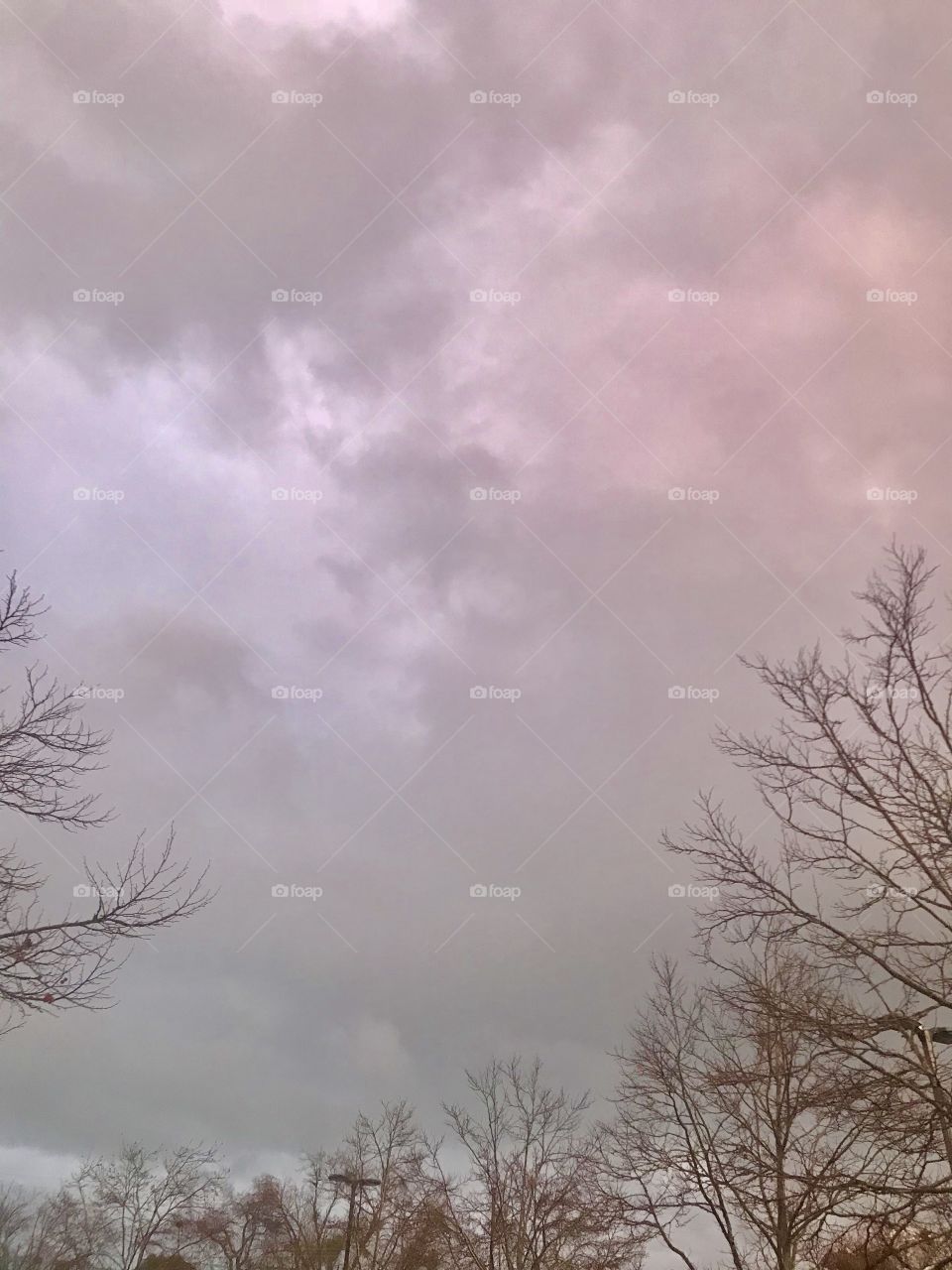 Beautiful purple, pink and gray cloudy skies on a winters night in the USA , America . 