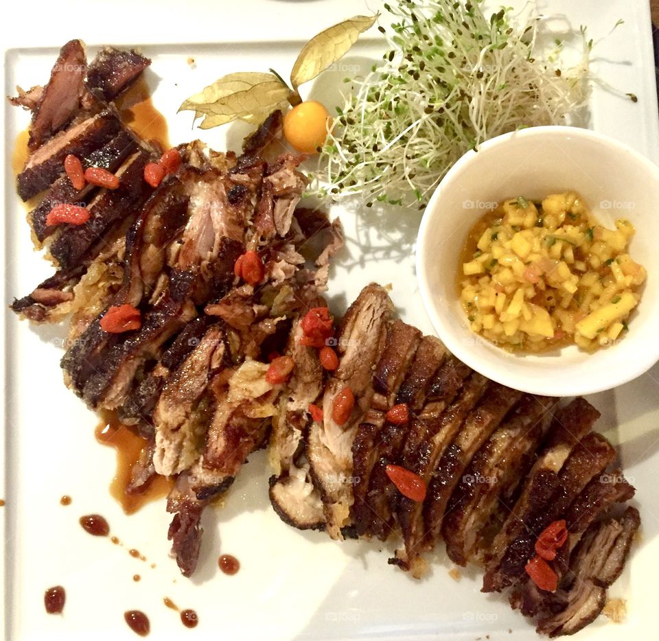 Roasted duck breast with mango sauce and goji berries