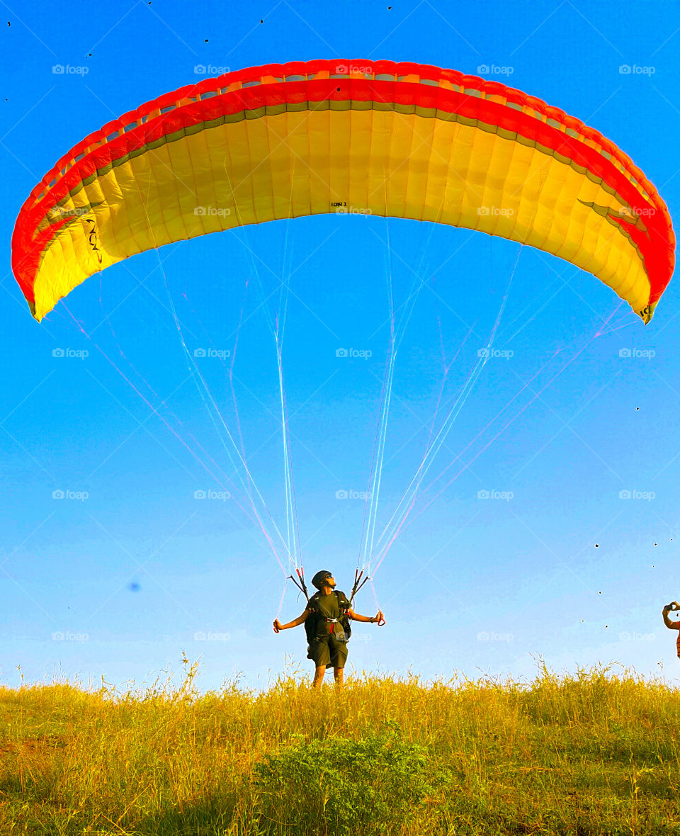 paragliding on a sunny day with blue sky