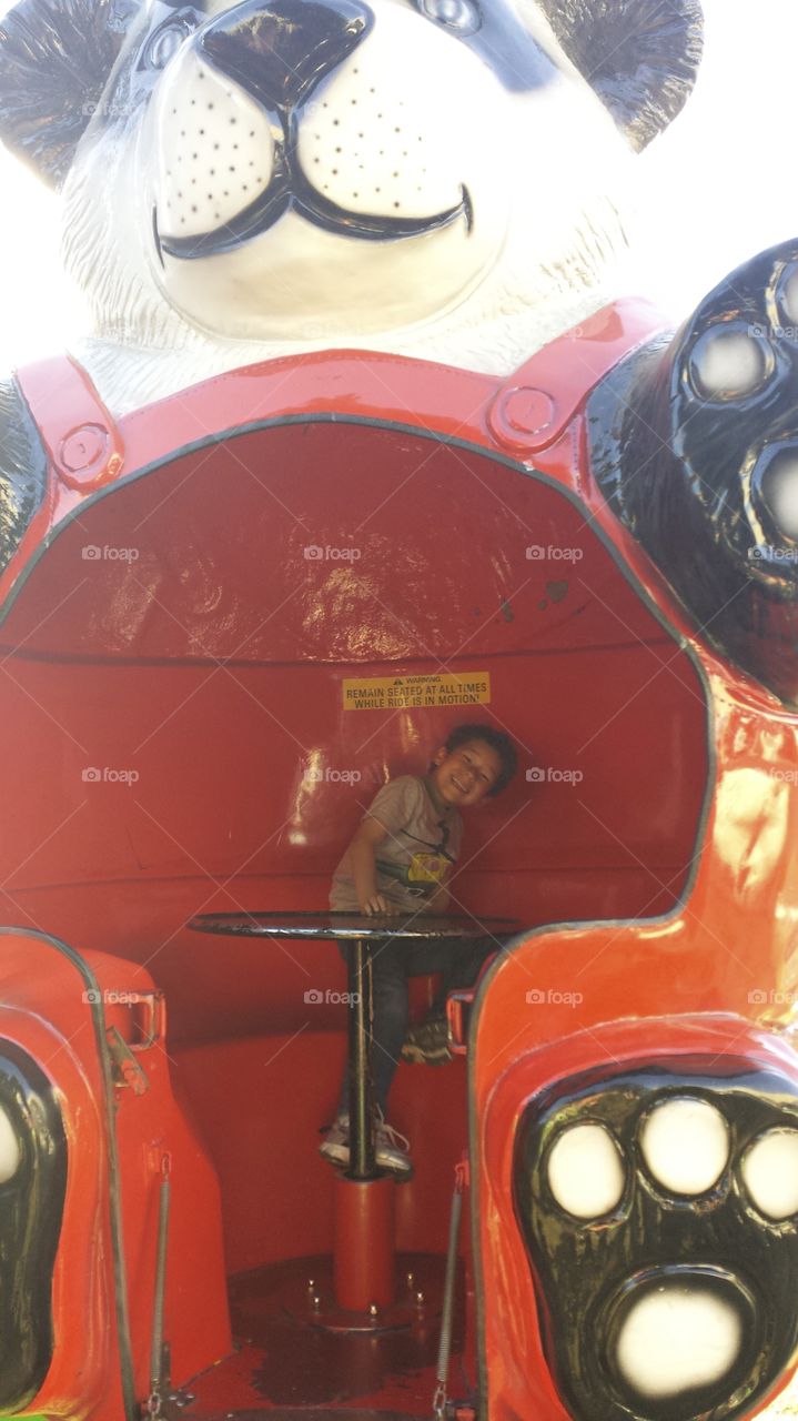 happy carnival ride. son having a blast at the fair