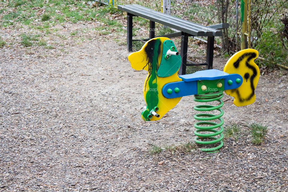 Kids playground with horse spring and graffiti urban scene vivid colors