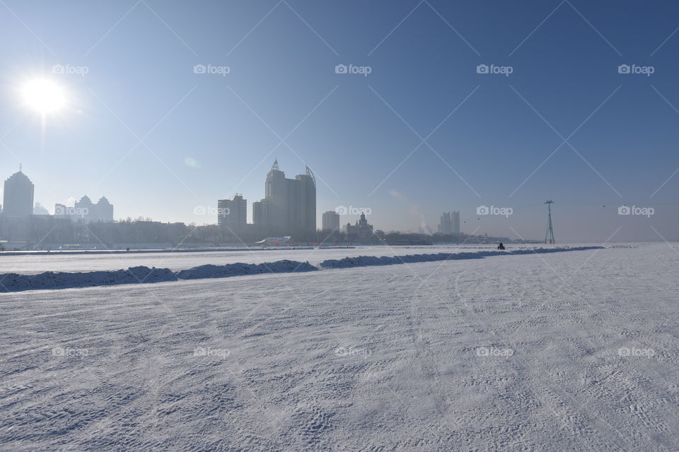 Asia china  Harbin ice Festival frozen river view to the city