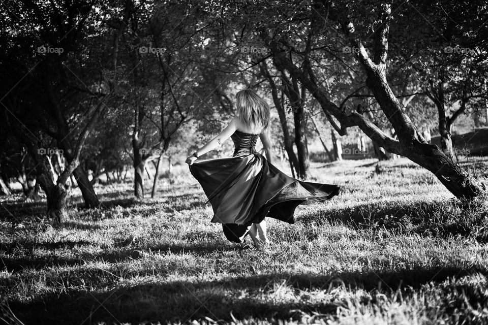 Girl in a dress dancing in the park