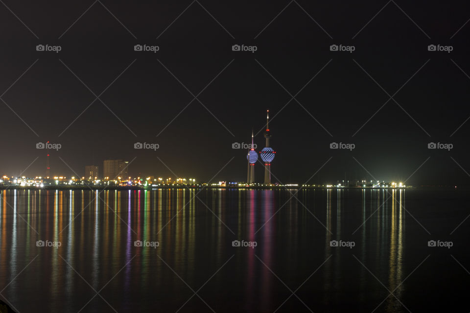 Reflection of illuminated skyscrapers on lake