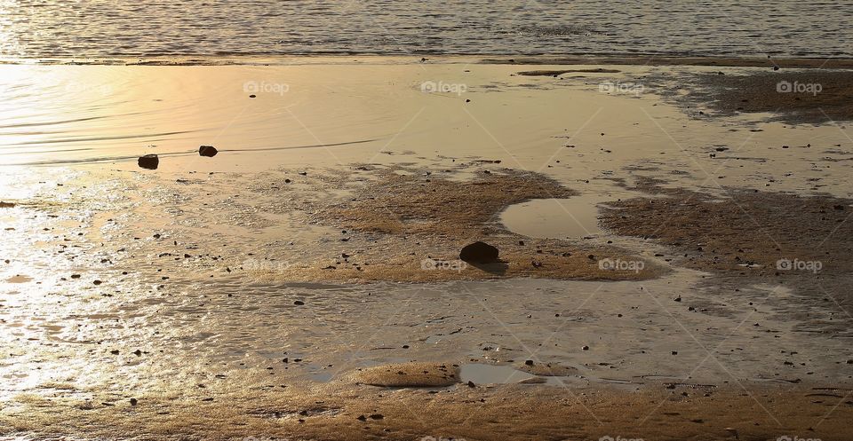 Golden reflection . Catching the golden hour reflecting off the sand and water - golden hour mission