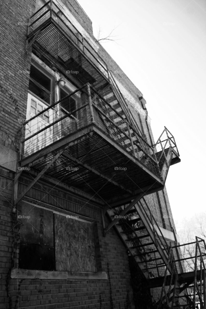A Black and White Escape . Fire escape on an abandoned building 