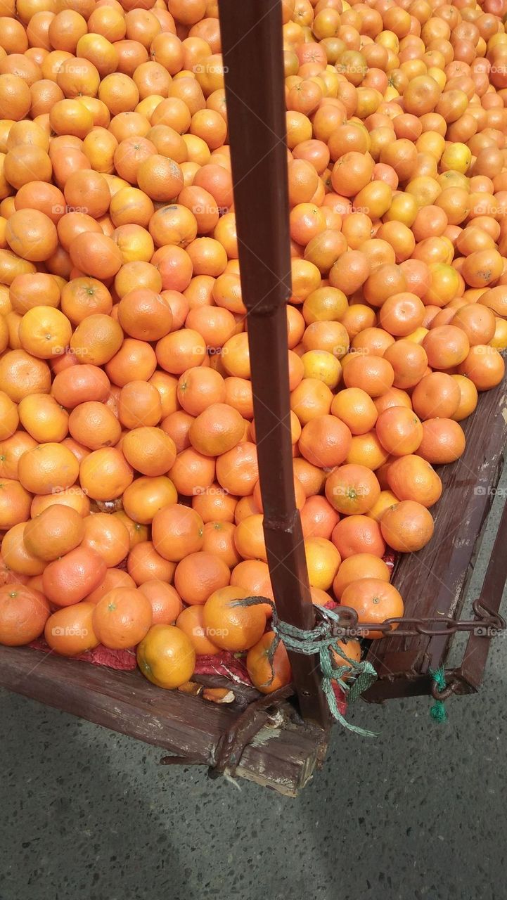 a wheelbarrow full of orange.