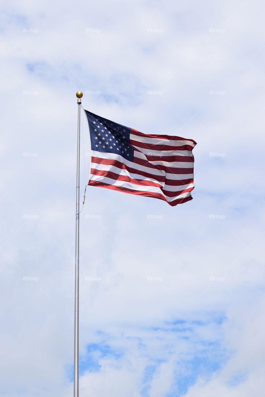 View of american flag against cloud sky
