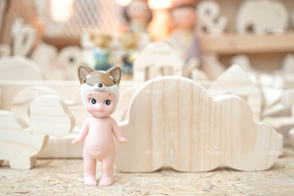 Bangkok, Thailand - September 24, 2017 : A photo of Sonny Angel or Baby Shower is standing among the woodwork handicrafts. Sonny Angel is very popular character in Japan. Editorial used only.