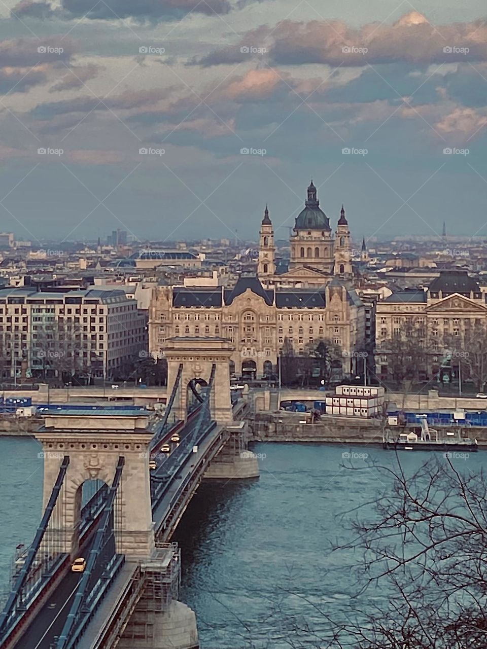Extraordinary architecture of chain bridge and St. Basilica church from the cast hill view on gloomy spring day