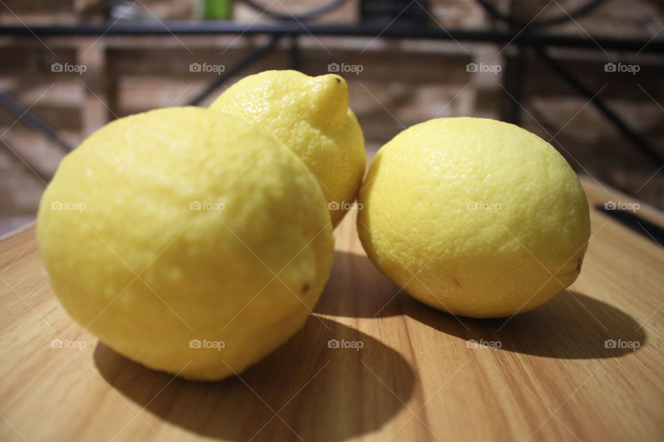 Three lemons on top of a table