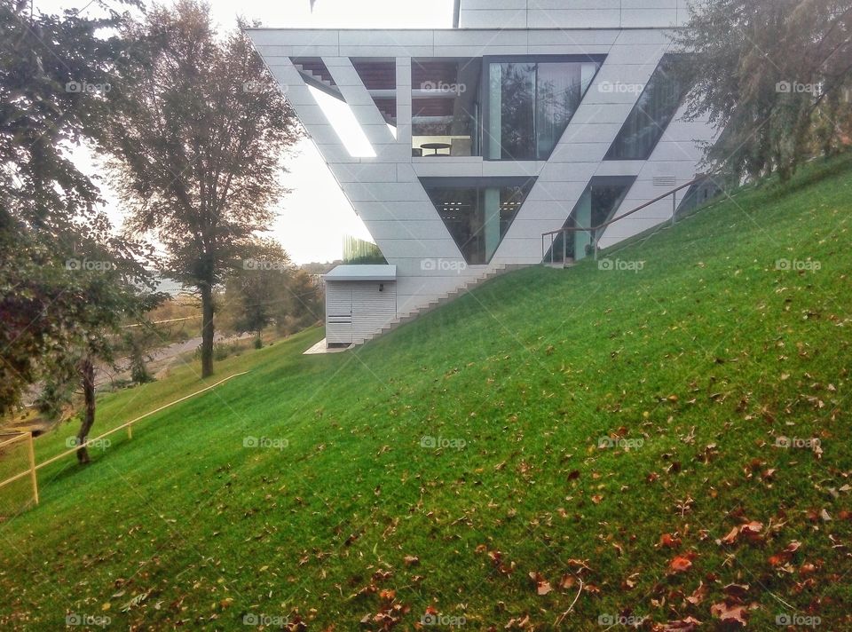 building on a green slope здание на