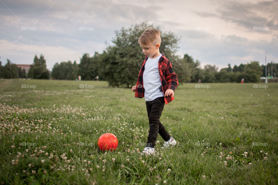 Little boy playing in soccer in a park 