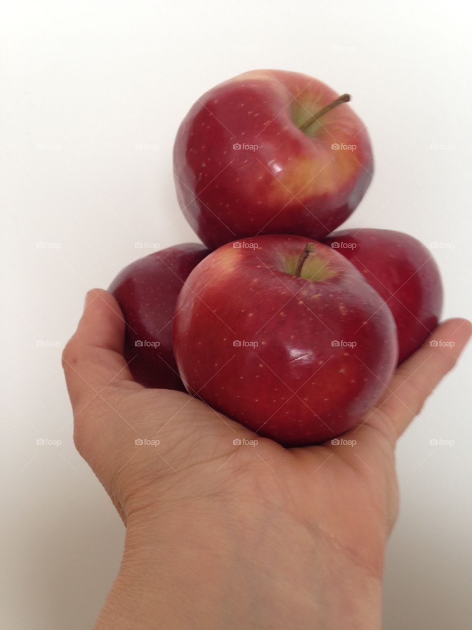 Person holding red apples in hand