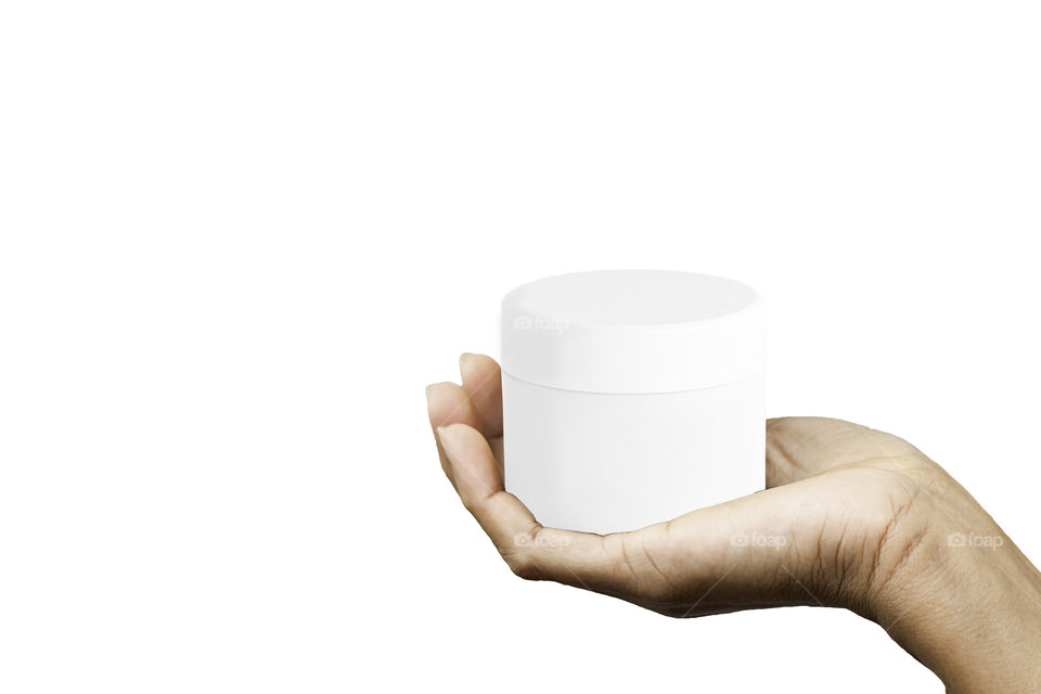 Isolated Hand holding White cosmetic jar on a white background with clipping path.