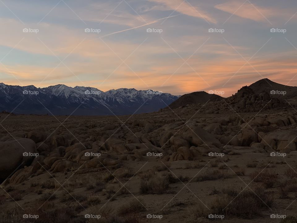 The setting sun over the Eastern Sierras in Lone Pine California glows orange in the sky!