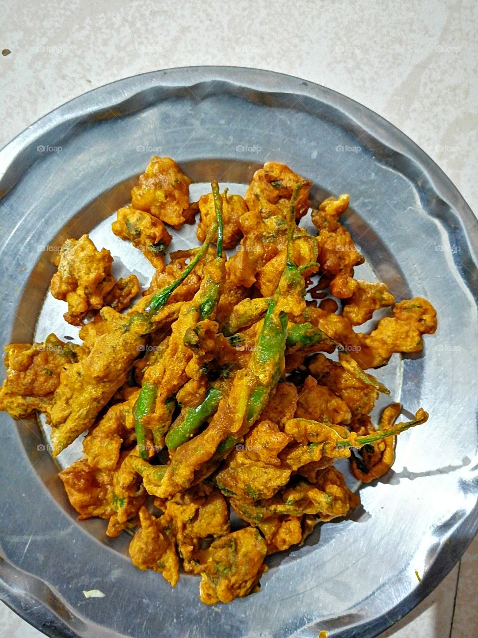Chilli spicy pakora  or Mirchi Vada or Crispy Mirchi Pakora can be perfect for our tea time evening snacks in this winter.The taste of stuffed mirchi fry is very tasty and delicious. Spicy chilli snacks,.