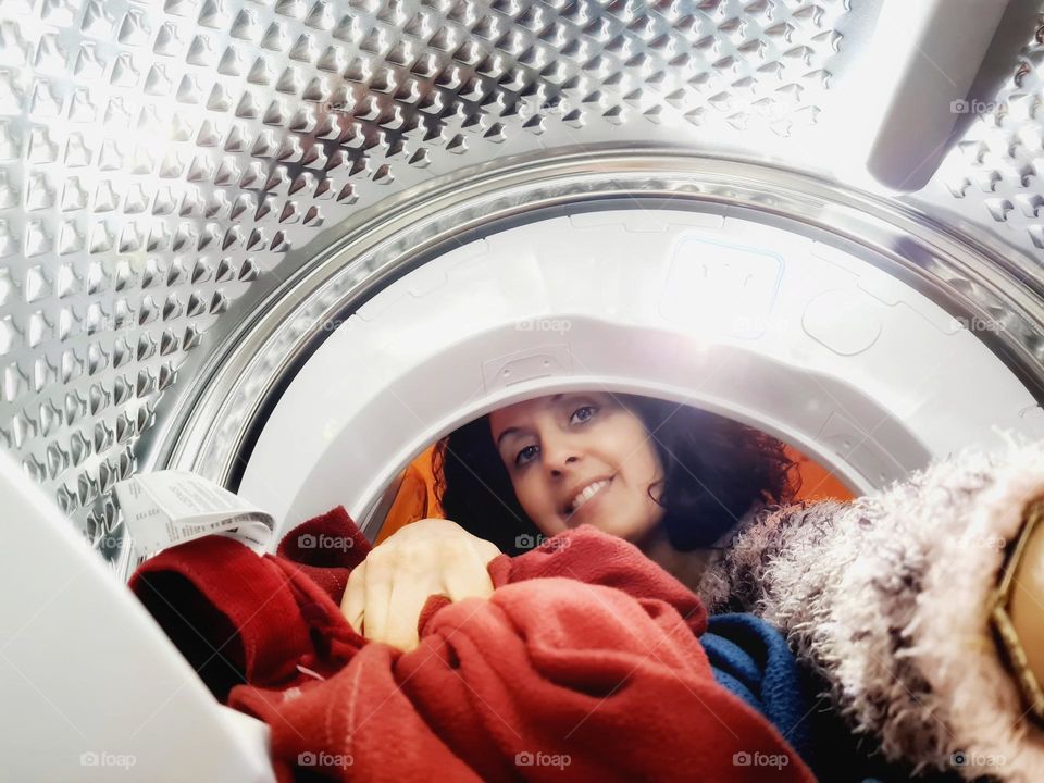 woman empties drum of dryer