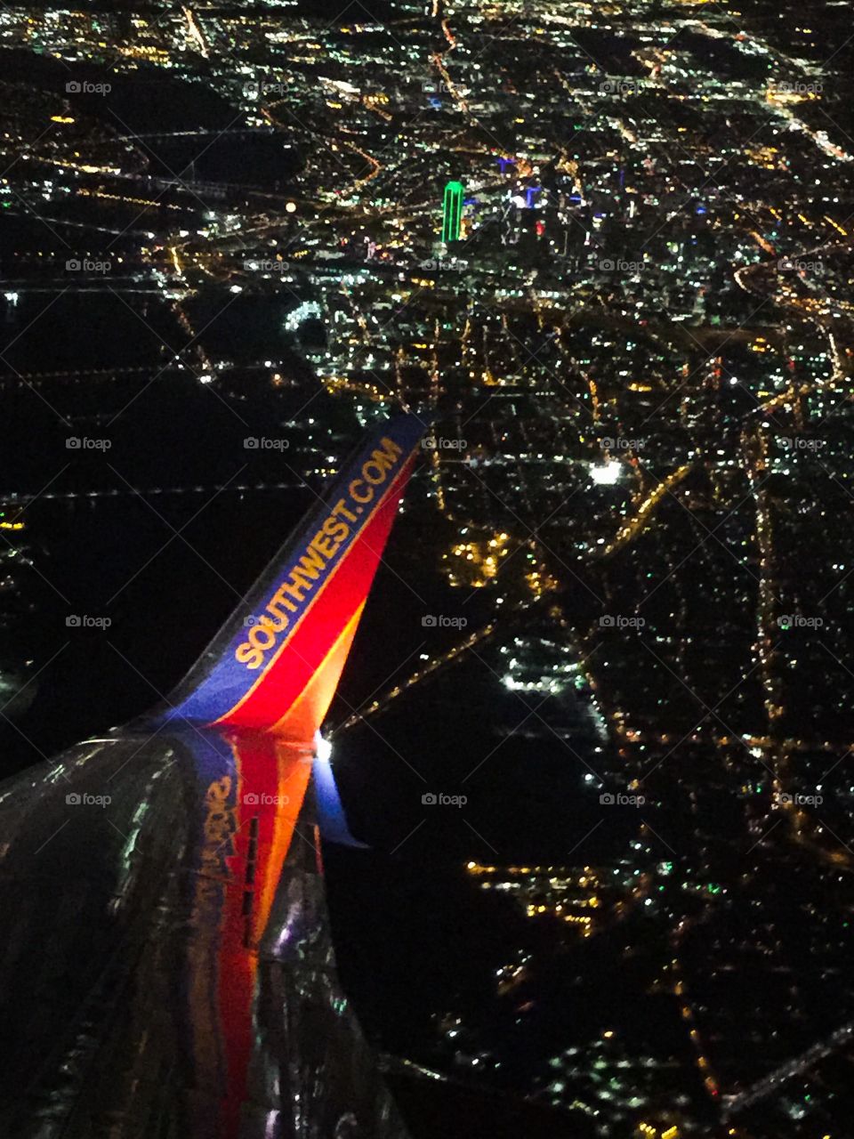 Aerial view of illuminated city against sky at night