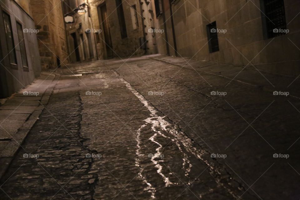 Empty cobblestone street in the night 