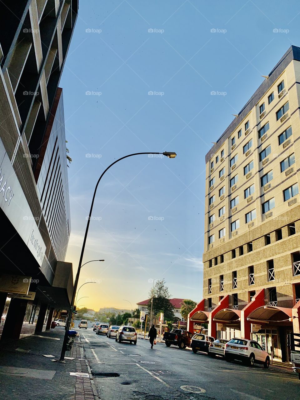 Beautiful sunset between tall buildings in the city center. A one stop at the pharmacy to grab some immune boosters. 