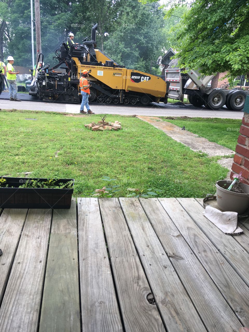 The road crew is working hard to resurface our street in our small town yesterday.