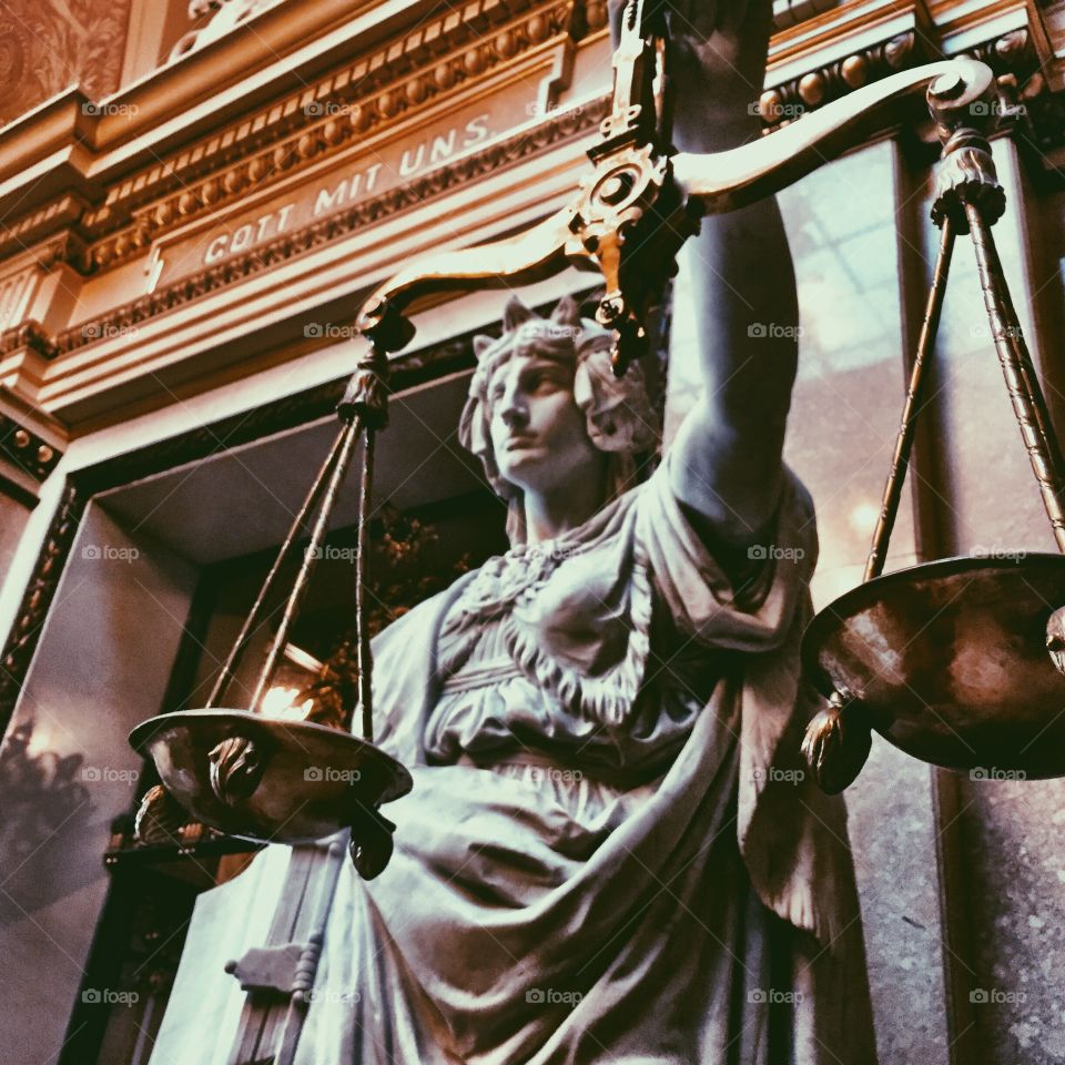 Lady of justice holding weighing scales in Rathaus Hamburg 
