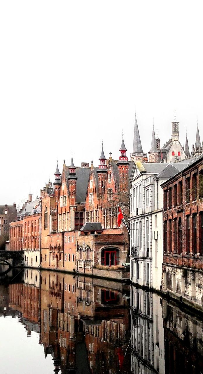 Old buildings alongside the canals of Bruges. Belgium.