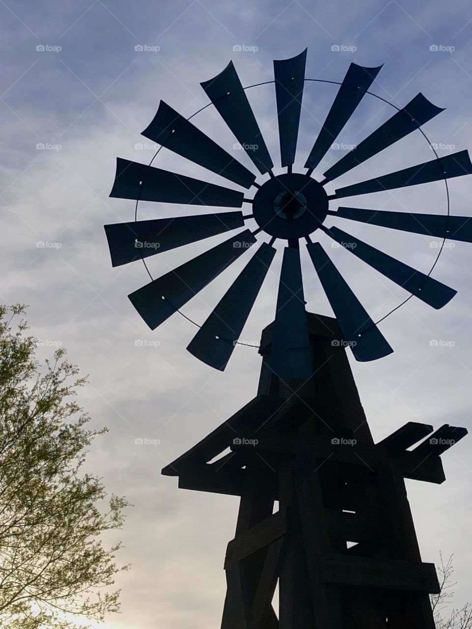 Closeup of the sun setting on the windmill in the front yard of the ranch in Texas - love how dark the windmill looks as the sun casts its shadows for the night!