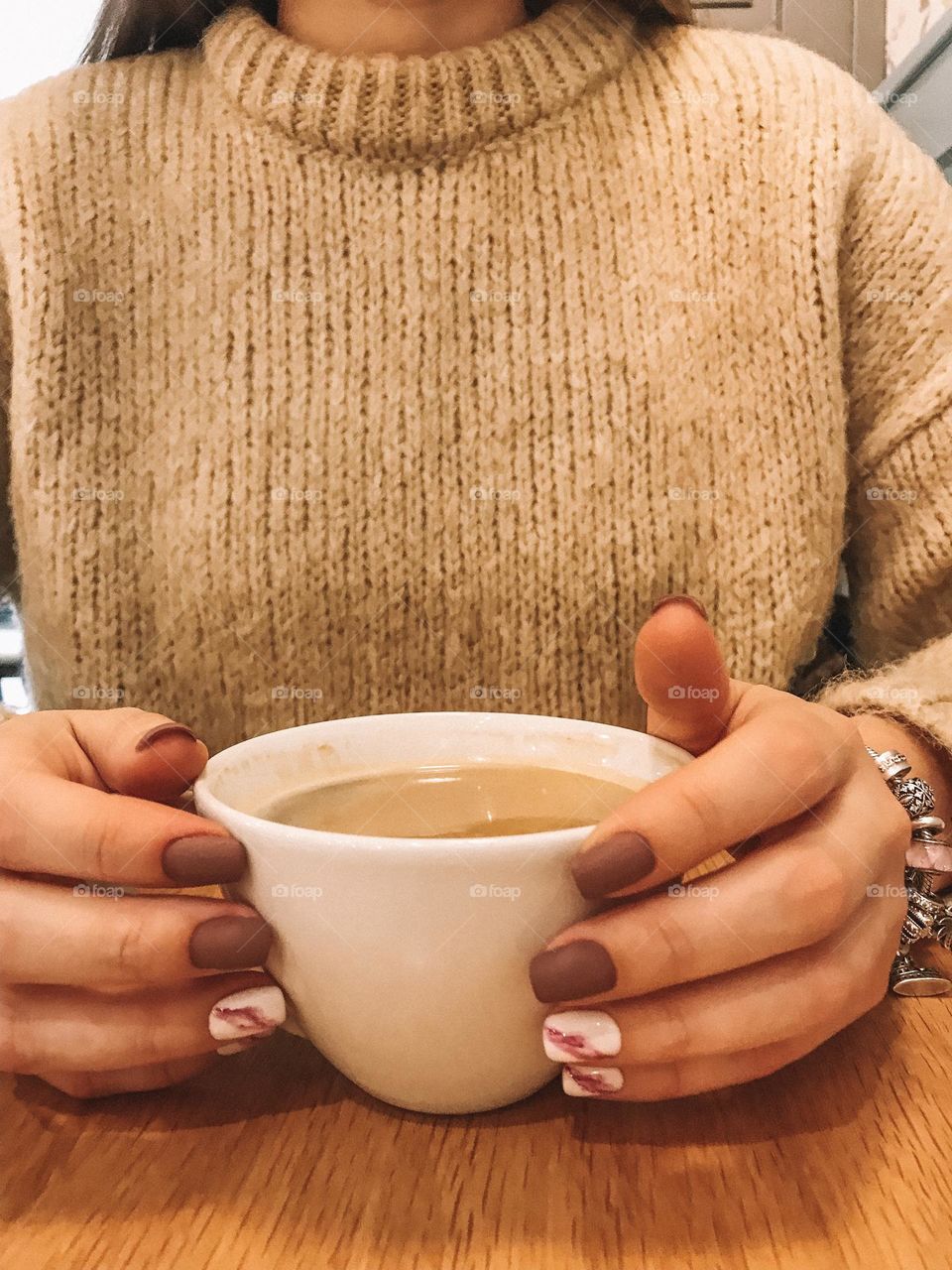 Woman manicure. Hands holding coffee tea cup. Female beautiful nails. 