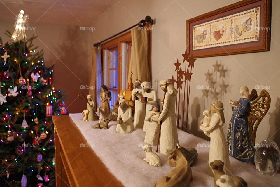 Christmas nativity scene figurines with a Christmas tree