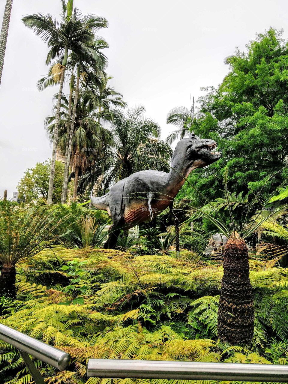 your local treasures: park surrounding the National Museum of Natural Science. show a giant dinosaur.