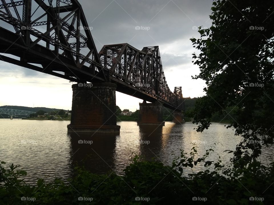 bridge over water near sunset